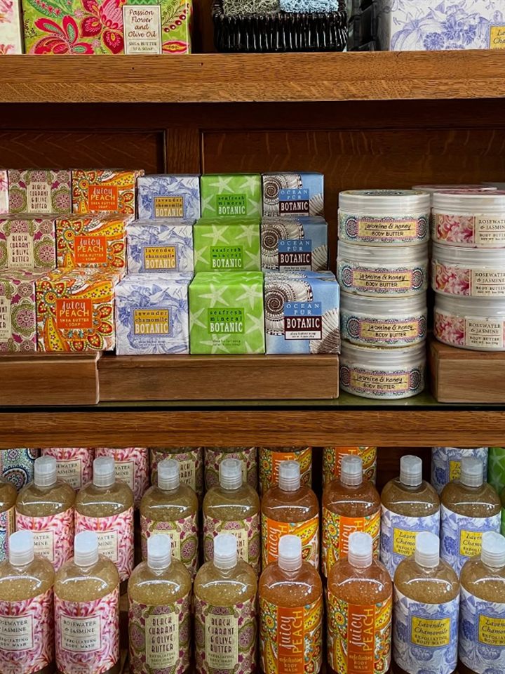 Shelves of botanic soaps, body butter tins, and exfoliating body wash bottles